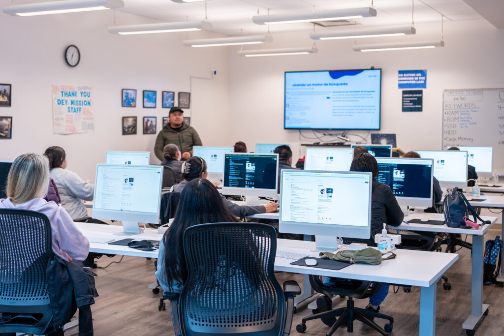 Students learning how to use a computer and fundamental tech skills