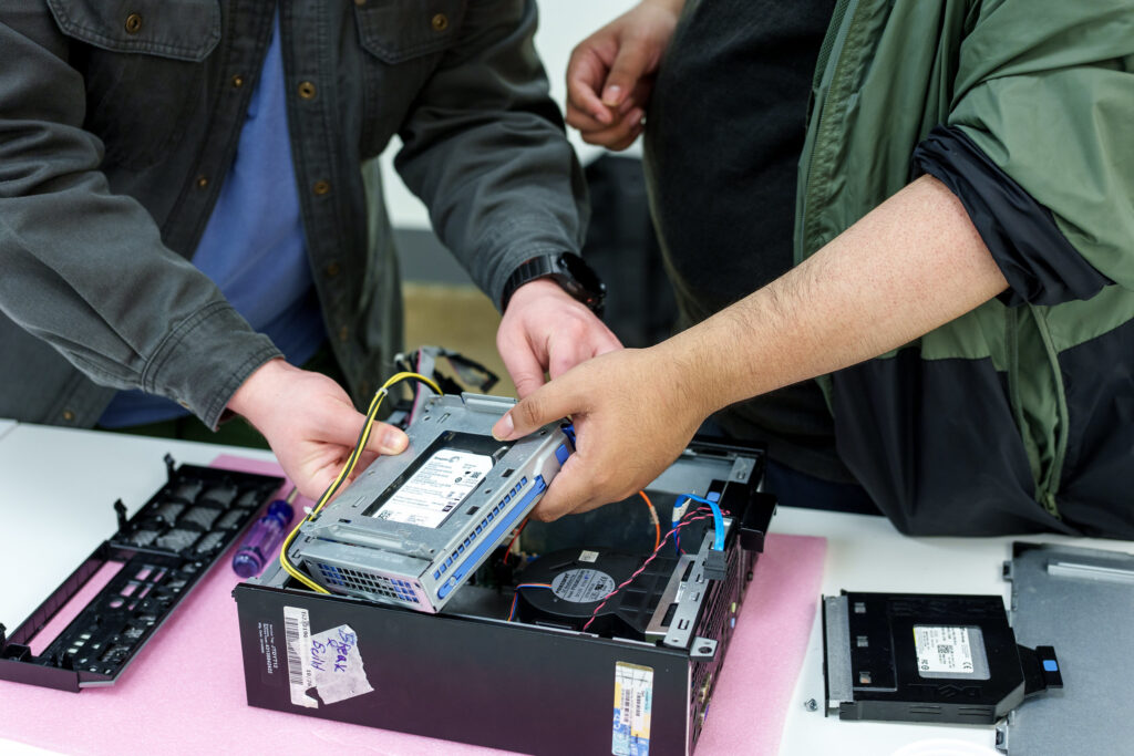 Trainees working together to take PC apart